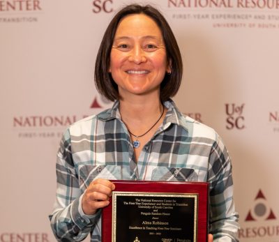 Physics instructor Alma Robinson holds her award for Excellence in Teaching First-Year Seminars.