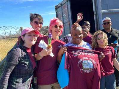 Four Virginia Tech students at a service learning project in South Africa