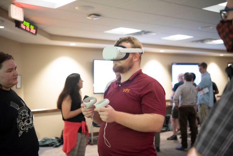 A student uses a VR headset at Newman Library during a digital poster presentation for the course HistoryLab. Photo by Ashley Wynn.